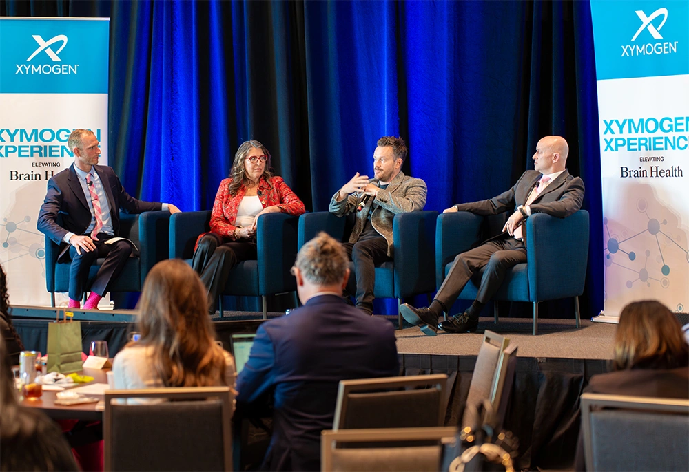 Dr. Will Cole leads a discussion on stage at the XYMOGEN XPERIENCE